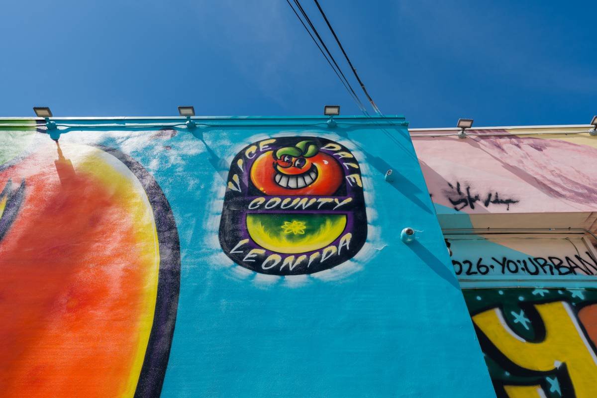 A Grand Theft Auto VI mural in Wynwood reading Vice Dade County, Leonida, painted on a building against a blue Miami sky